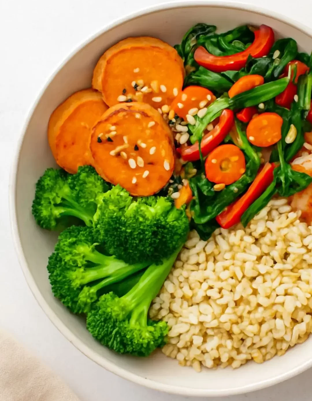 Prato vegano com legumes grelhados, quinoa, folhas verdes, homus e vegetais crus